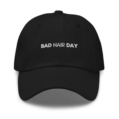 a black hat with white sarcastic, bad hair day, text on it