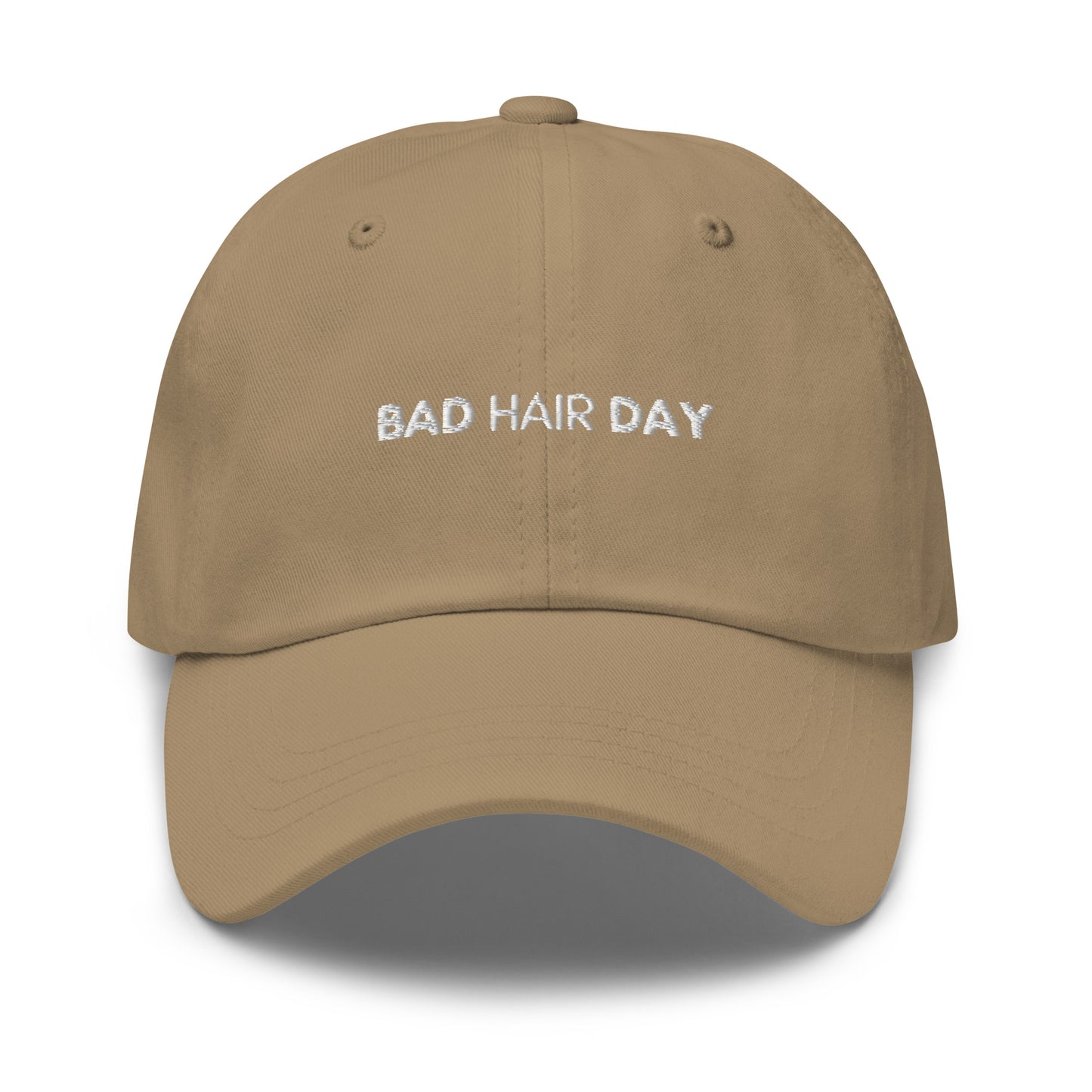 a beige or khaki hat with white sarcastic, bad hair day, text on it