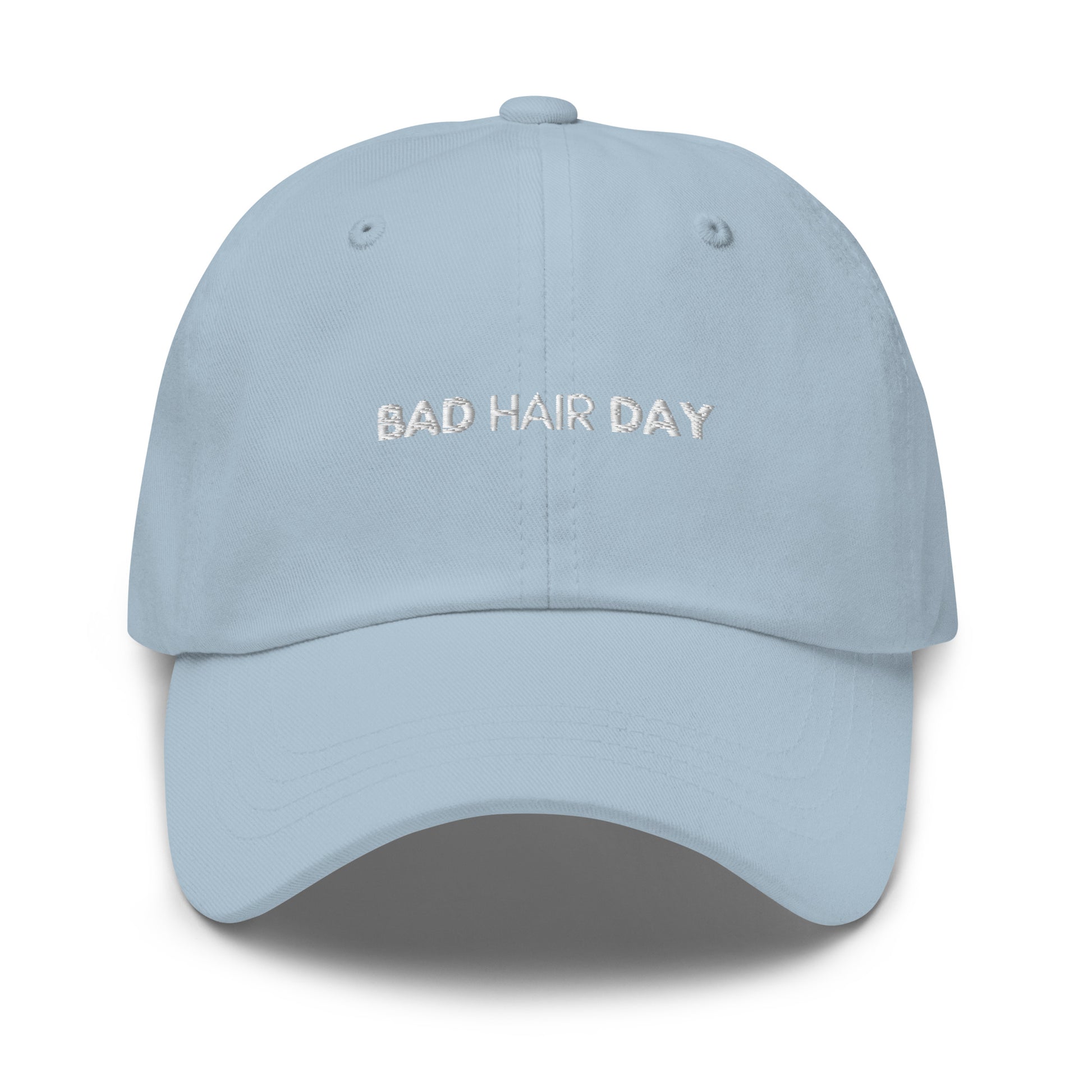 a light hat with white sarcastic, bad hair day, text on it