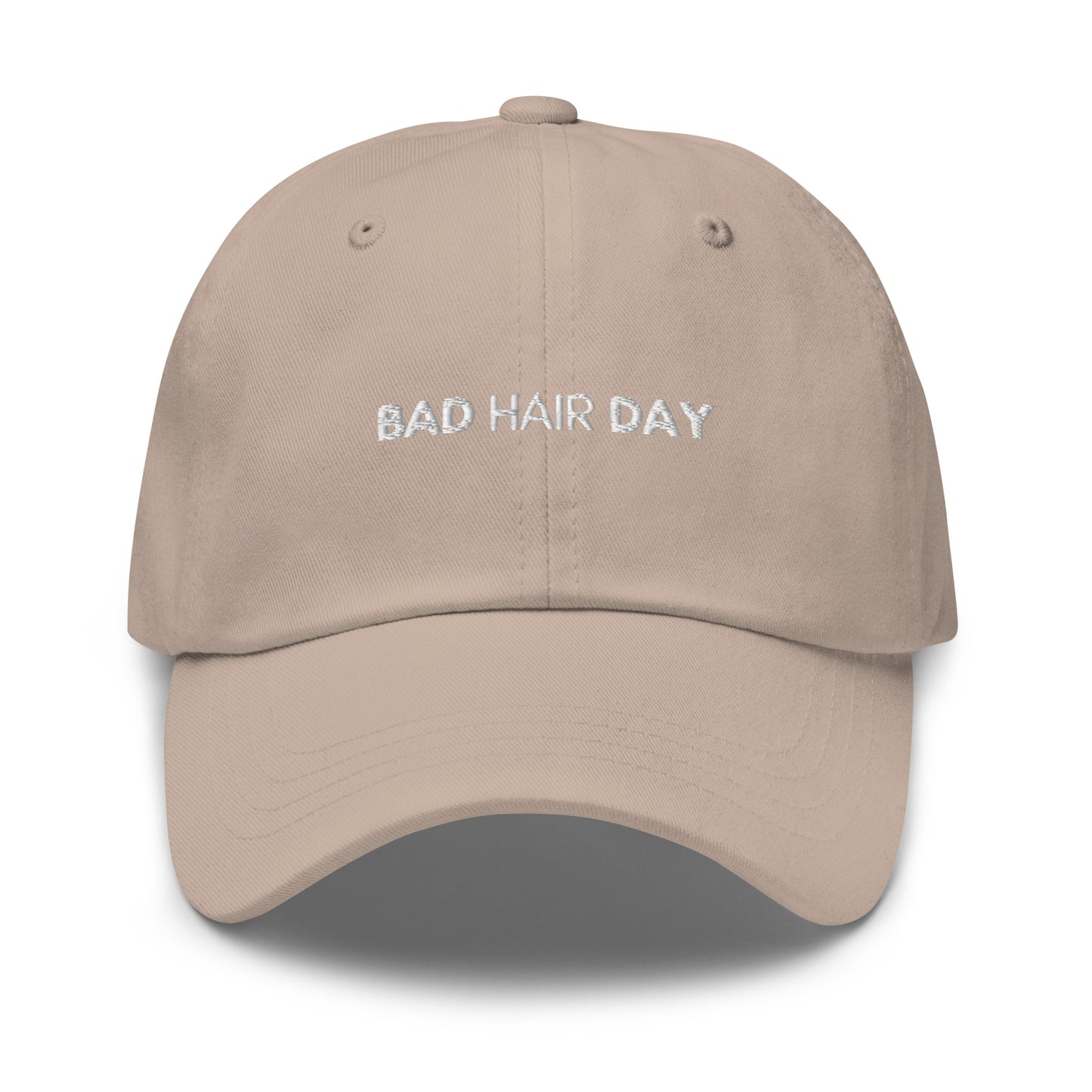 a stone color hat with white sarcastic, bad hair day, text on it